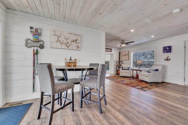 A rustic house with a rack for pet leashes on the wall.